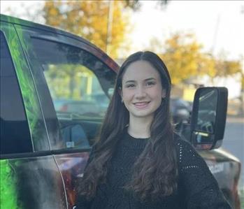 woman in black sweater smiling