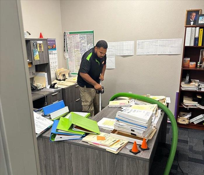 using a water vacuum on a carpeted office