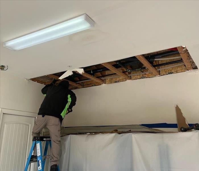 man removing ceiling from water damage