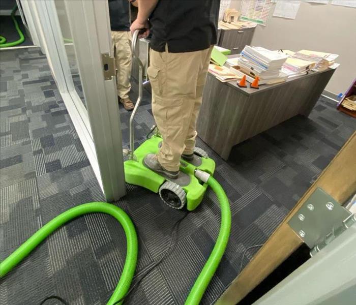 technician using a ride on water extractor