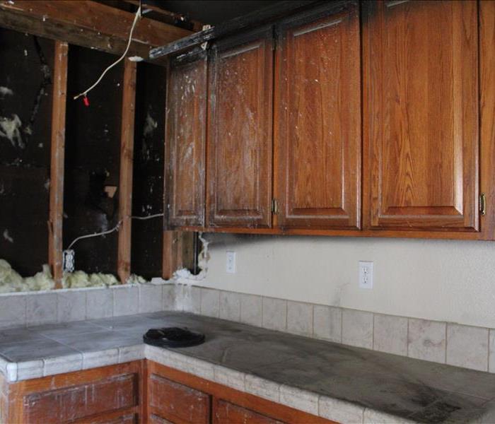 wood cabinets with tile countertop and fire damage in kitchen near north highlands